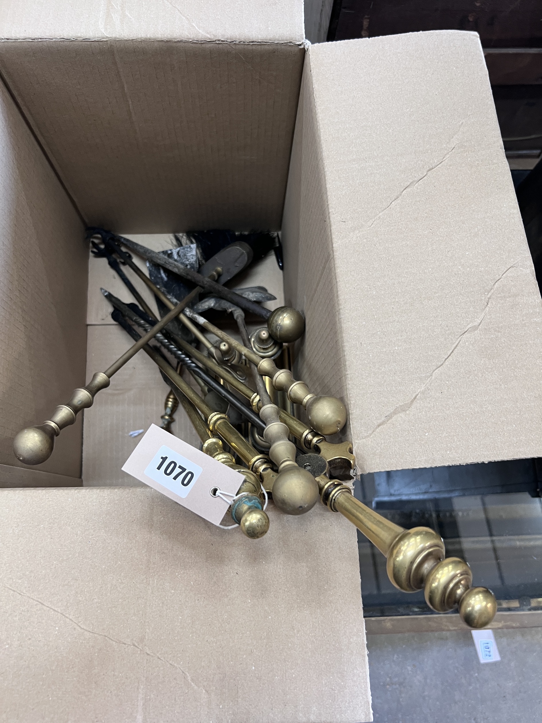 A collection of assorted fire implements and a pair of brass fire dogs
